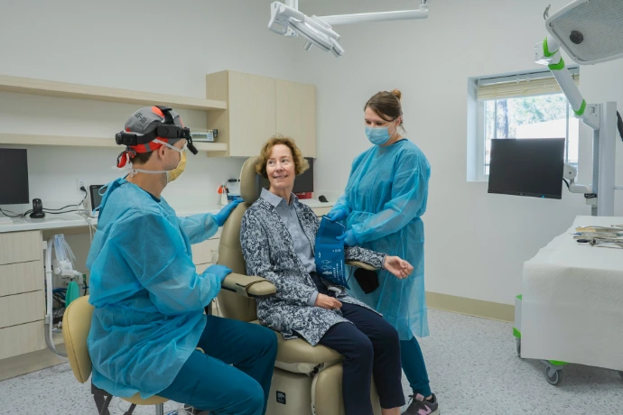 A group of people in a dental room